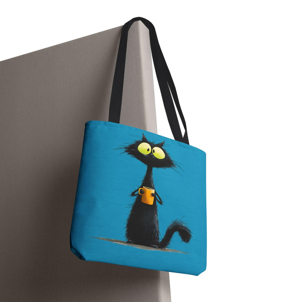 Wide-Eyed Black Cat Holding Coffee Tote Bag | Cute Cartoon Cat Illustration