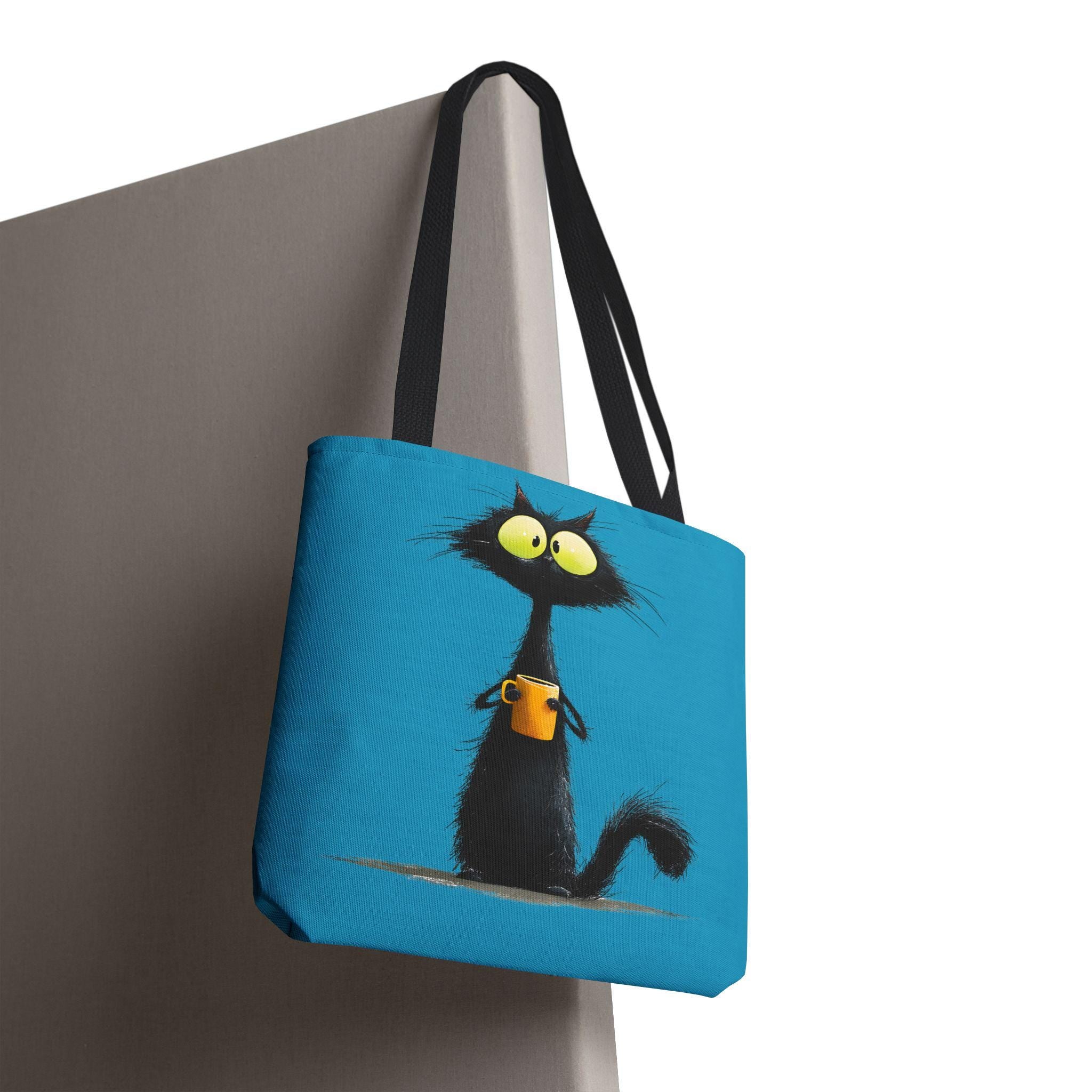 Wide-Eyed Black Cat Holding Coffee Tote Bag | Cute Cartoon Cat Illustration