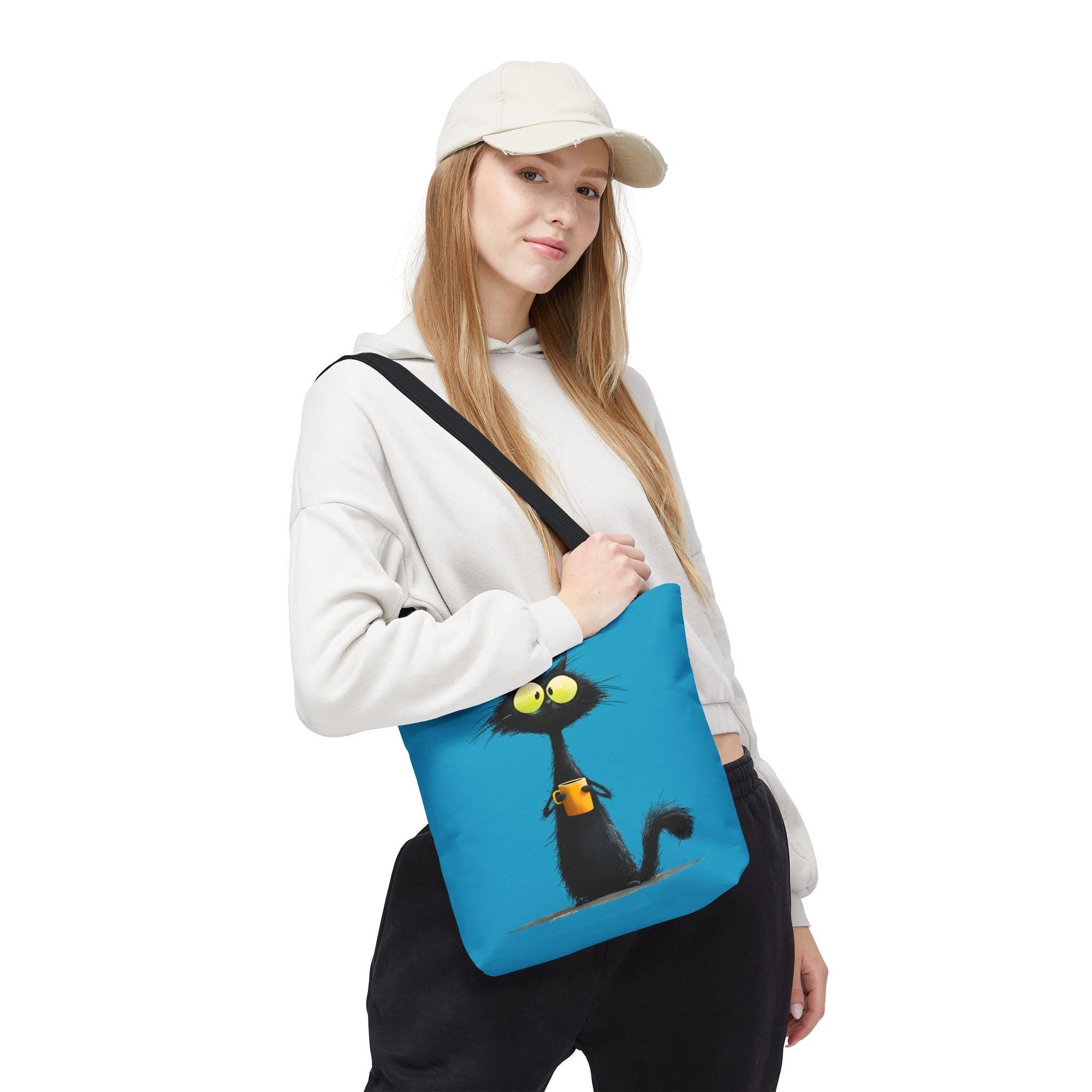 Wide-Eyed Black Cat Holding Coffee Tote Bag | Cute Cartoon Cat Illustration